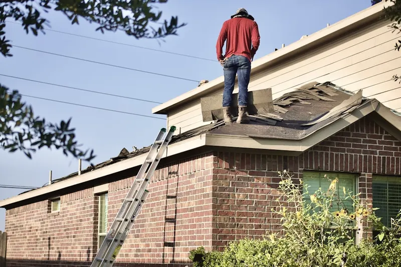 Professional roofer working on a residential roof in Los Alamos Hills